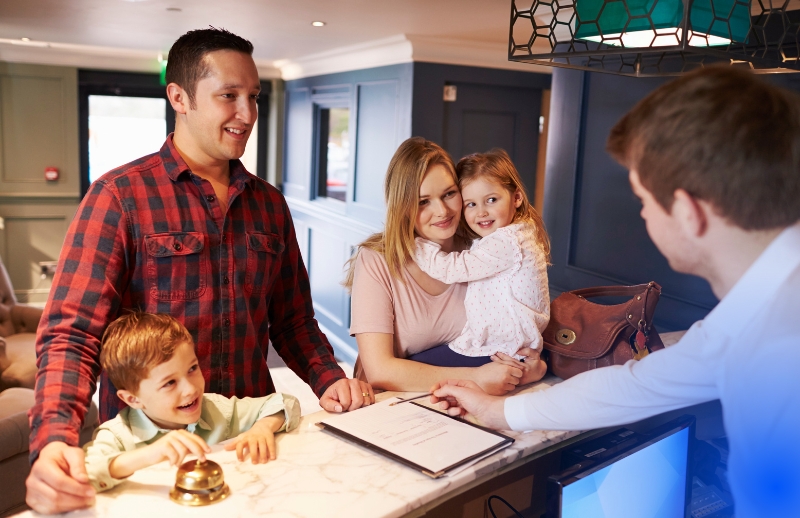 Family Checking In A Hotel